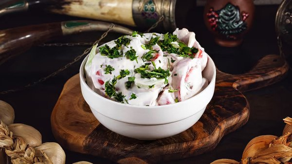 Cucumber tomato salad with mayonnaise - Georgian dish at Tbilisuri Ezo restaurant in Tbilisi }}