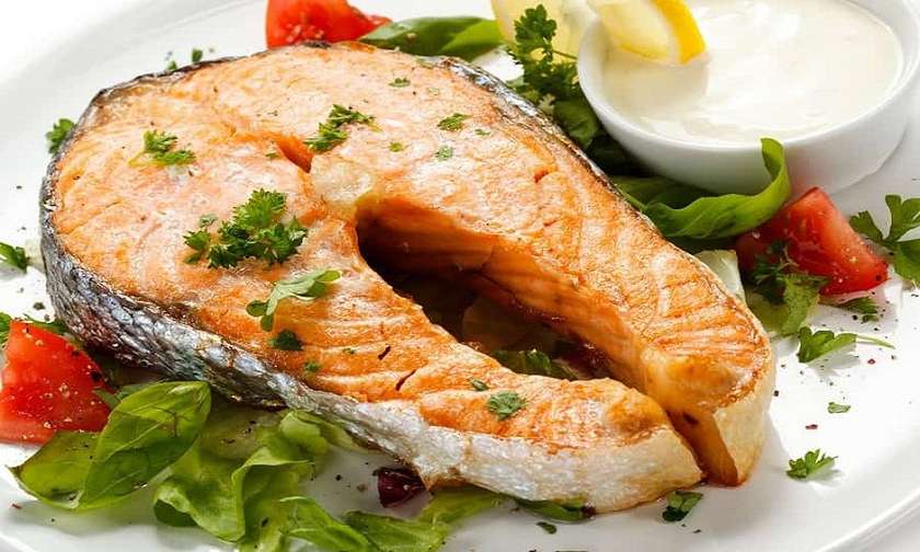 Salmon steak with rice garnish - Georgian dish at Tbilisuri Ezo restaurant in Tbilisi }}