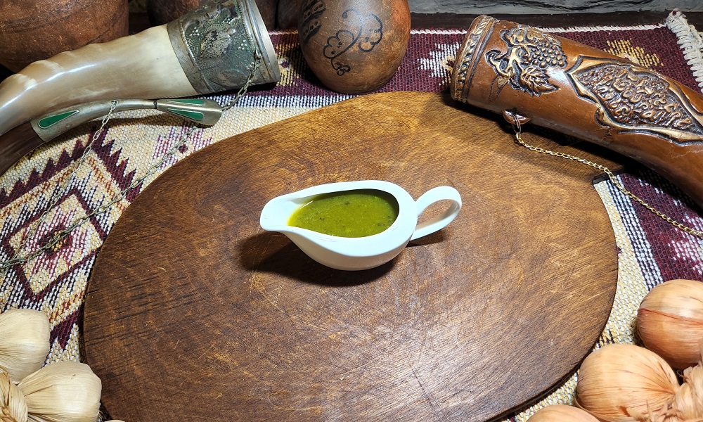 Tkemali - Georgian dish at Tbilisuri Ezo restaurant in Tbilisi }}