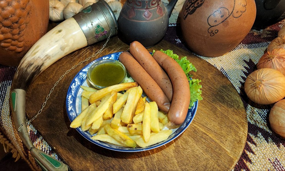Sausage With Fries - Georgian dish at Tbilisuri Ezo restaurant in Tbilisi }}