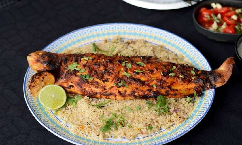 Fried Trout With Rice - Georgian dish at Tbilisuri Ezo restaurant in Tbilisi }}